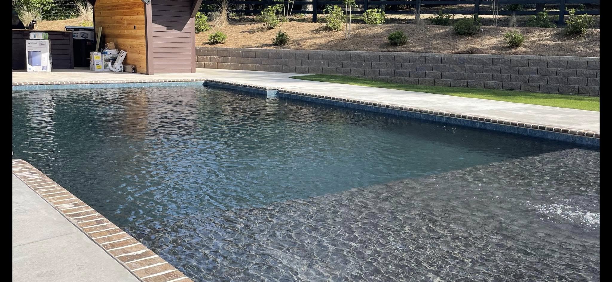 Custom in-ground pool with paver deck and retaining wall โ Southern Nature Custom Pools, Augusta GA